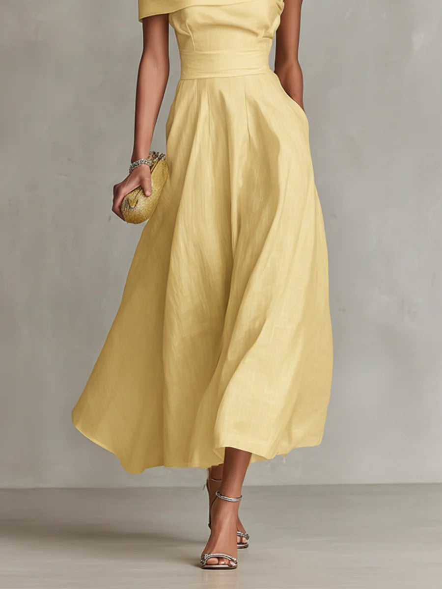 Yellow one-shoulder maxi dress with draped bodice and flowing skirt
