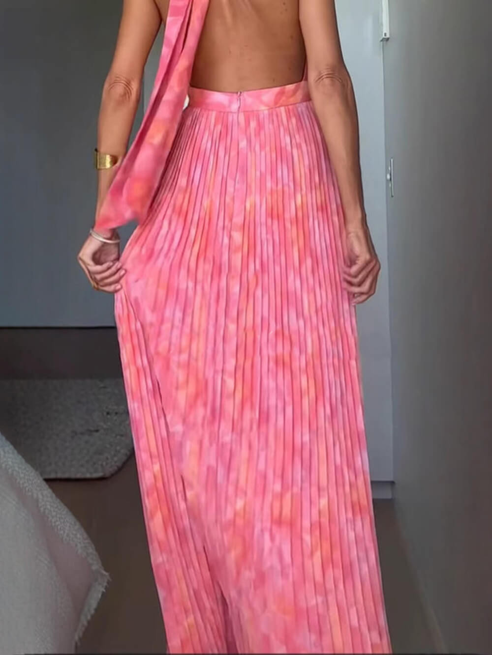 Women's pink abstract halter maxi dress with deep neckline and pleated full-length skirt