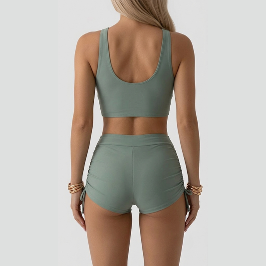 Women's green ruched bikini set with V-neck top and high-waisted shorts