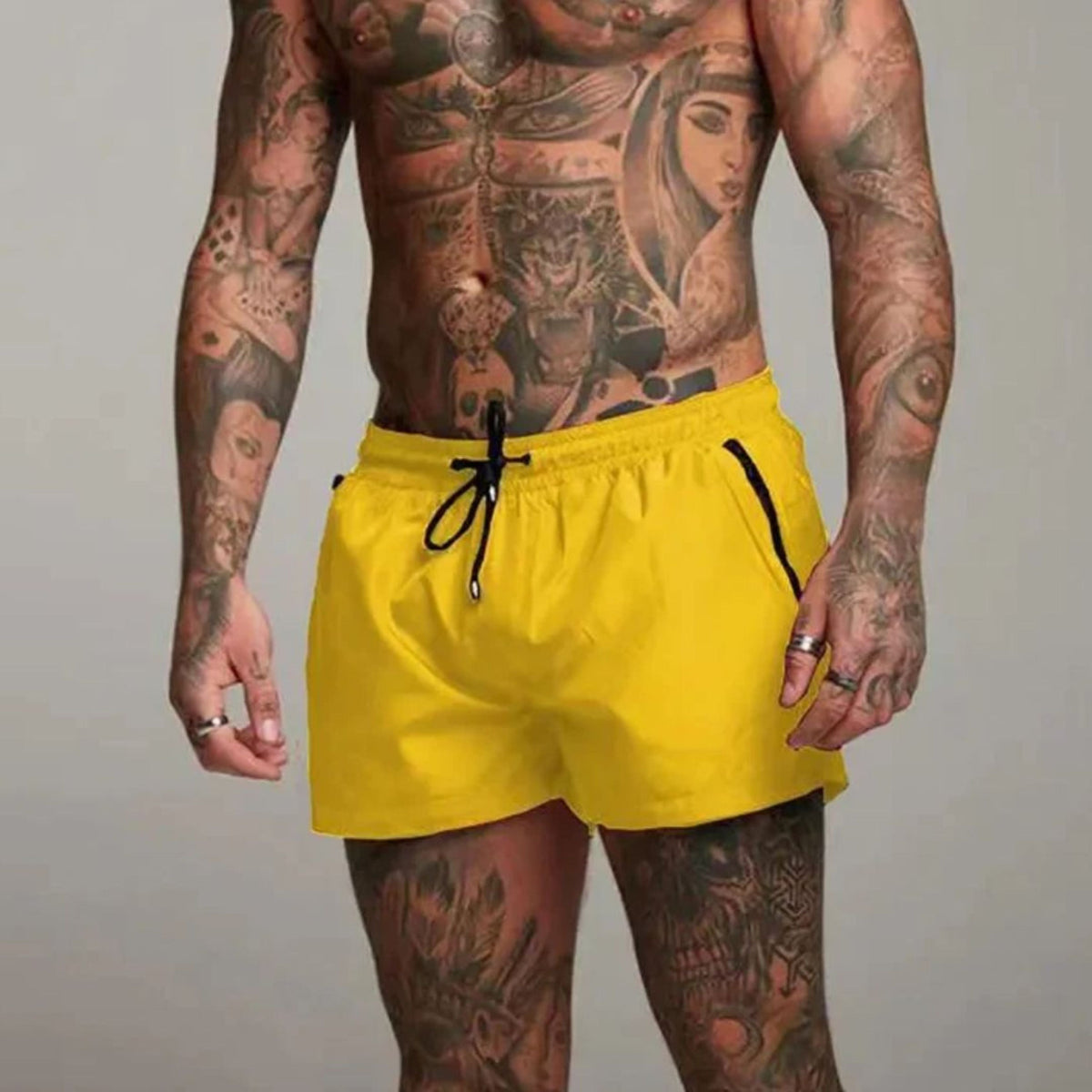 Men's plain swim shorts with elasticated drawstring waist and zipped side pockets