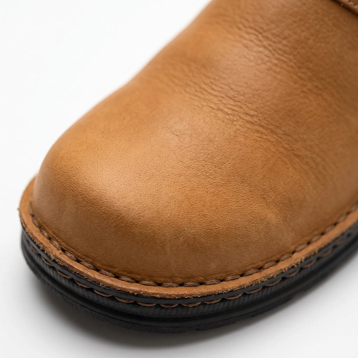 Men's closed-toe mule shoes with buckle straps and raised black soles
