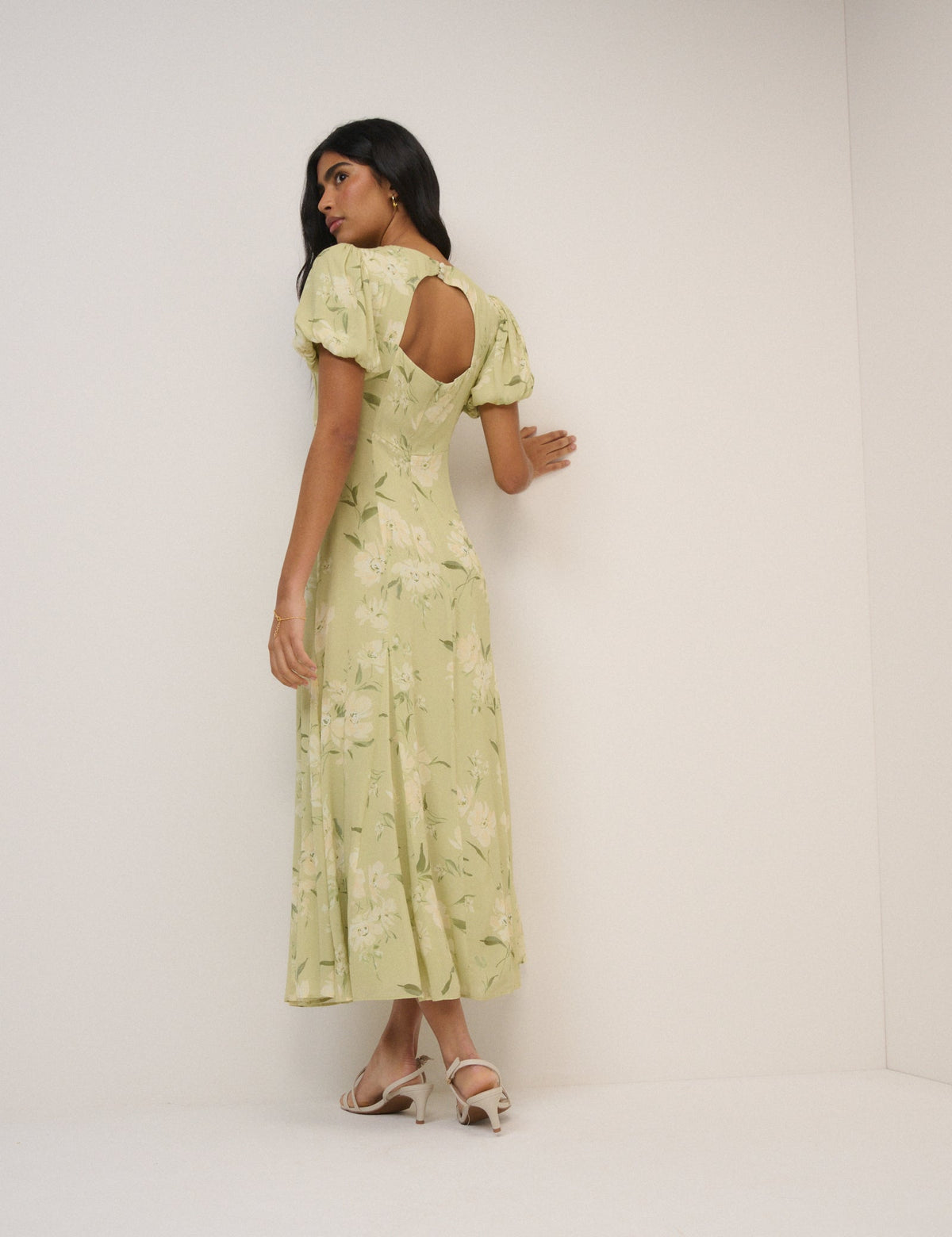 Women's pale green floral maxi dress with short puff sleeves and open back