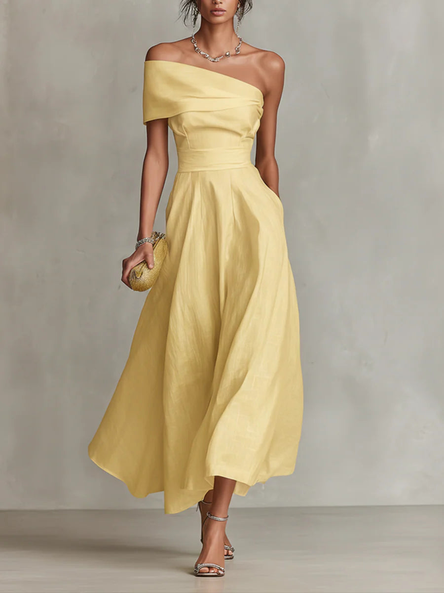 Yellow one-shoulder maxi dress with draped bodice and flowing skirt