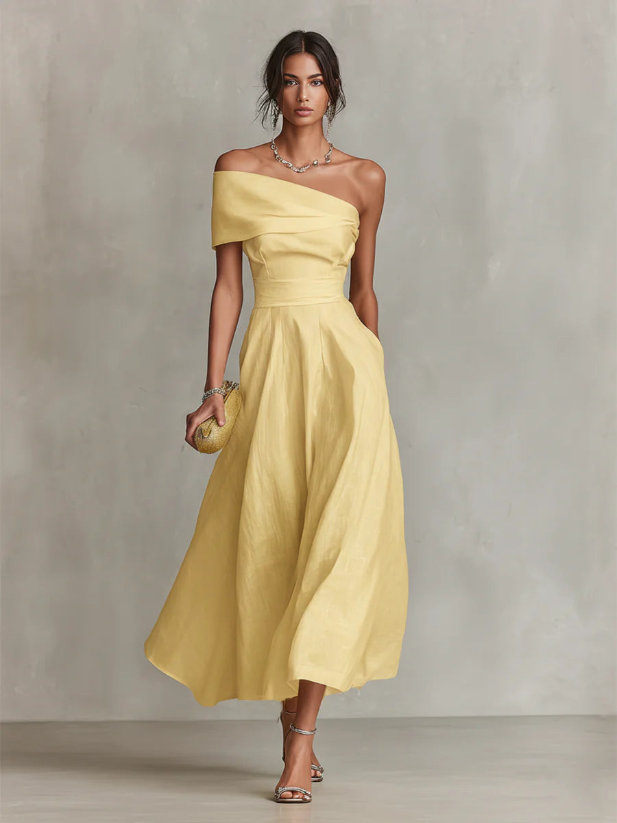 Yellow one-shoulder maxi dress with draped bodice and flowing skirt