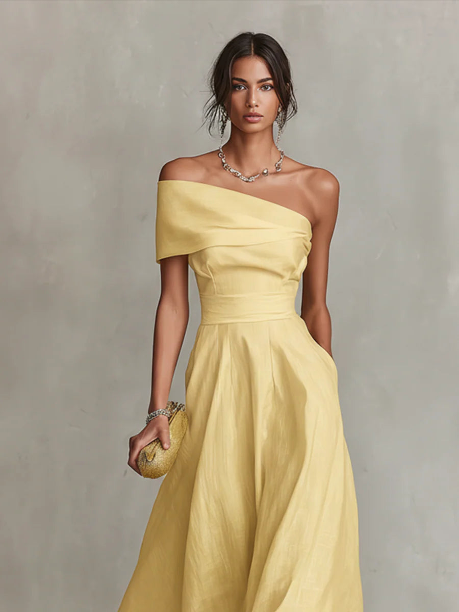 Yellow one-shoulder maxi dress with draped bodice and flowing skirt