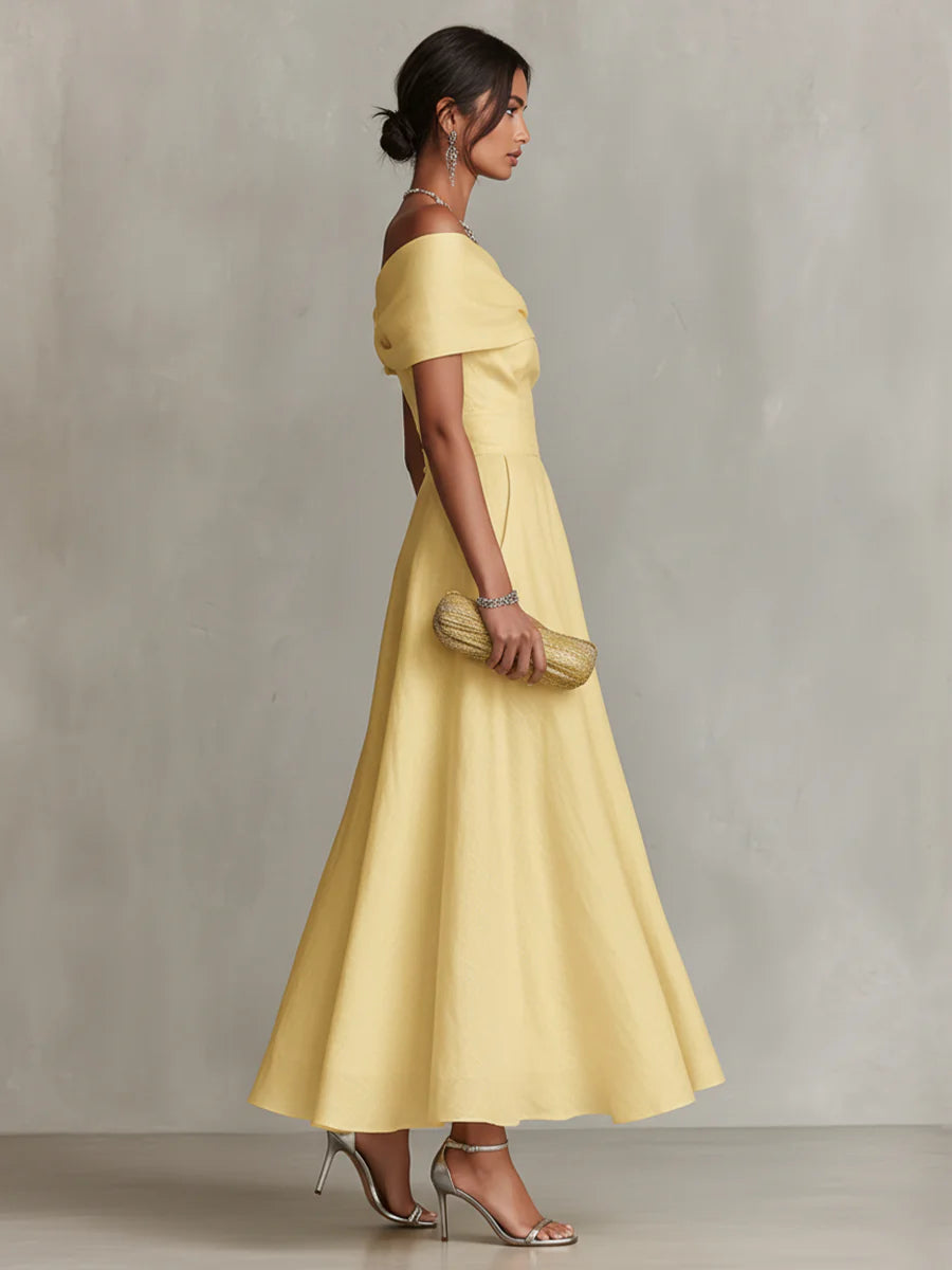 Yellow one-shoulder maxi dress with draped bodice and flowing skirt