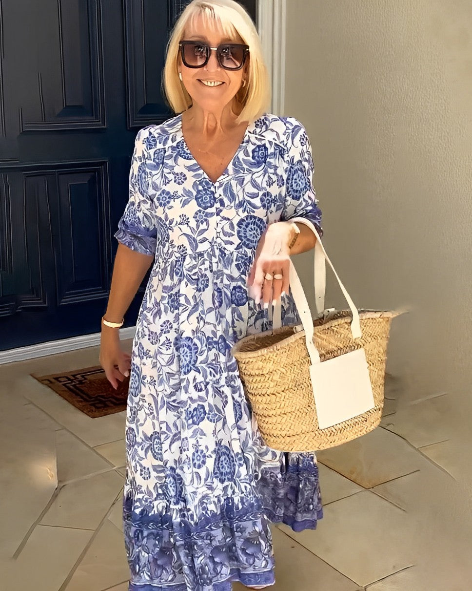 Women's floral V-neck midi dress with three-quarter sleeves and tiered skirt