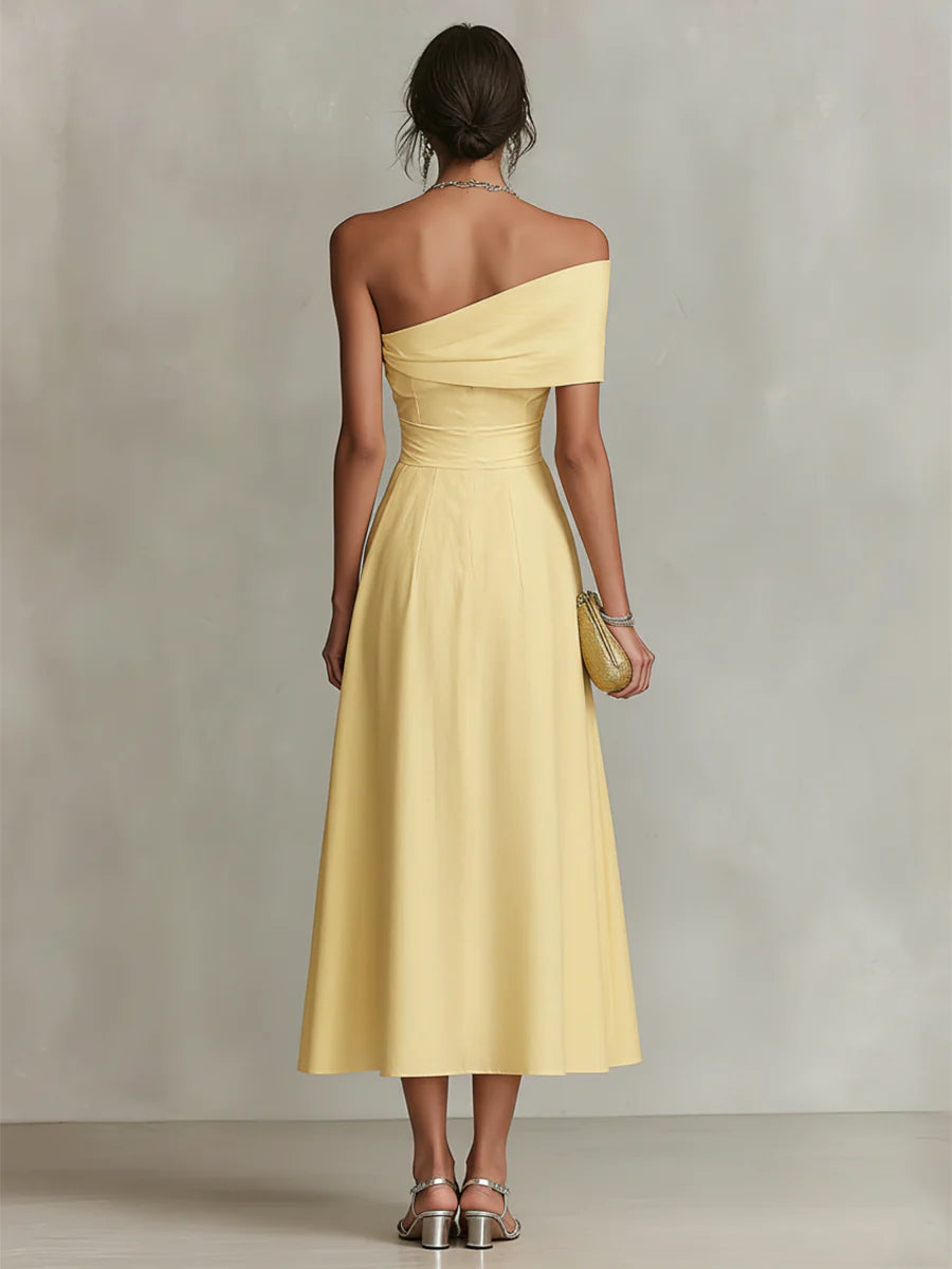 Yellow one-shoulder maxi dress with draped bodice and flowing skirt