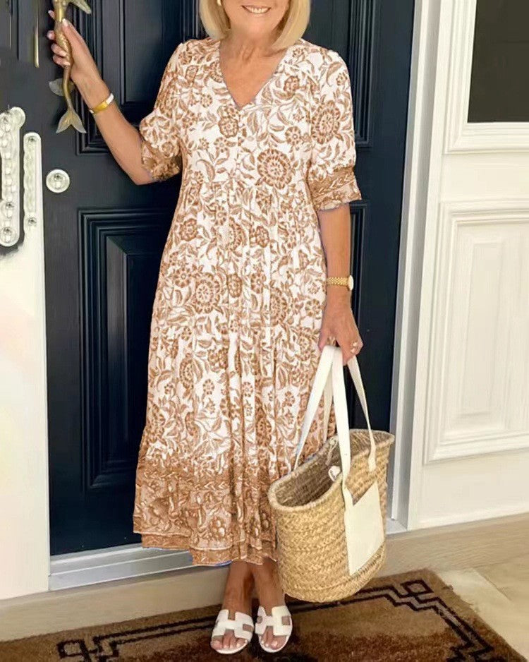 Women's floral V-neck midi dress with three-quarter sleeves and tiered skirt