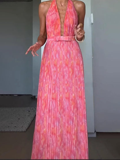 Women's pink abstract halter maxi dress with deep neckline and pleated full-length skirt