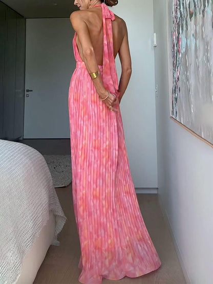 Women's pink abstract halter maxi dress with deep neckline and pleated full-length skirt