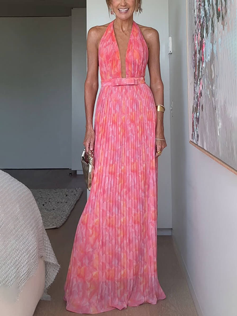 Women's pink abstract halter maxi dress with deep neckline and pleated full-length skirt