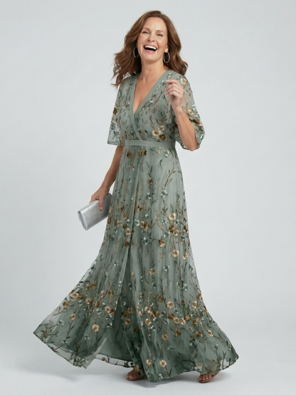 Women's green floral wrap maxi dress with V-neckline and flutter sleeves