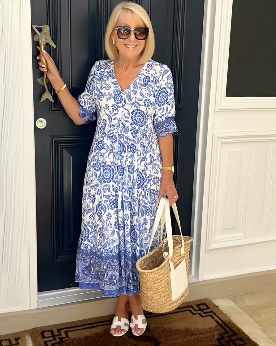 Women's floral V-neck midi dress with three-quarter sleeves and tiered skirt