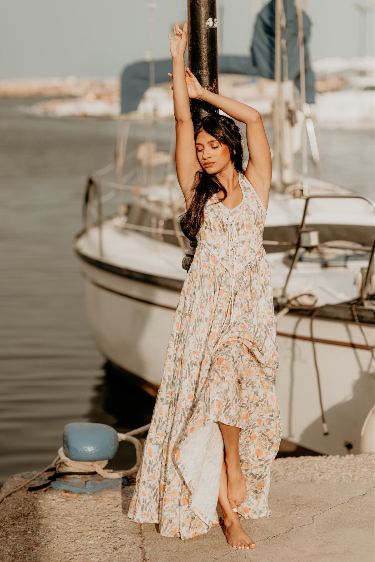 Women's sleeveless lace-up corset maxi dress with a full floral skirt