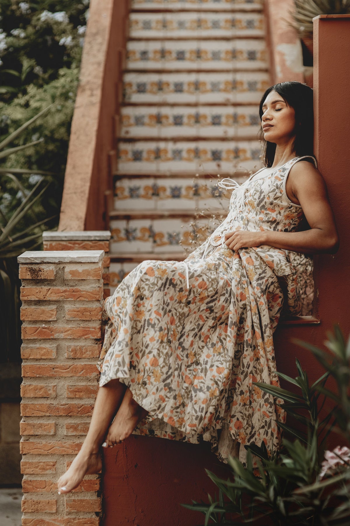 Women's sleeveless lace-up corset maxi dress with a full floral skirt