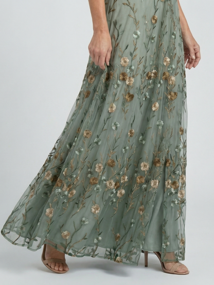 Women's green floral wrap maxi dress with V-neckline and flutter sleeves