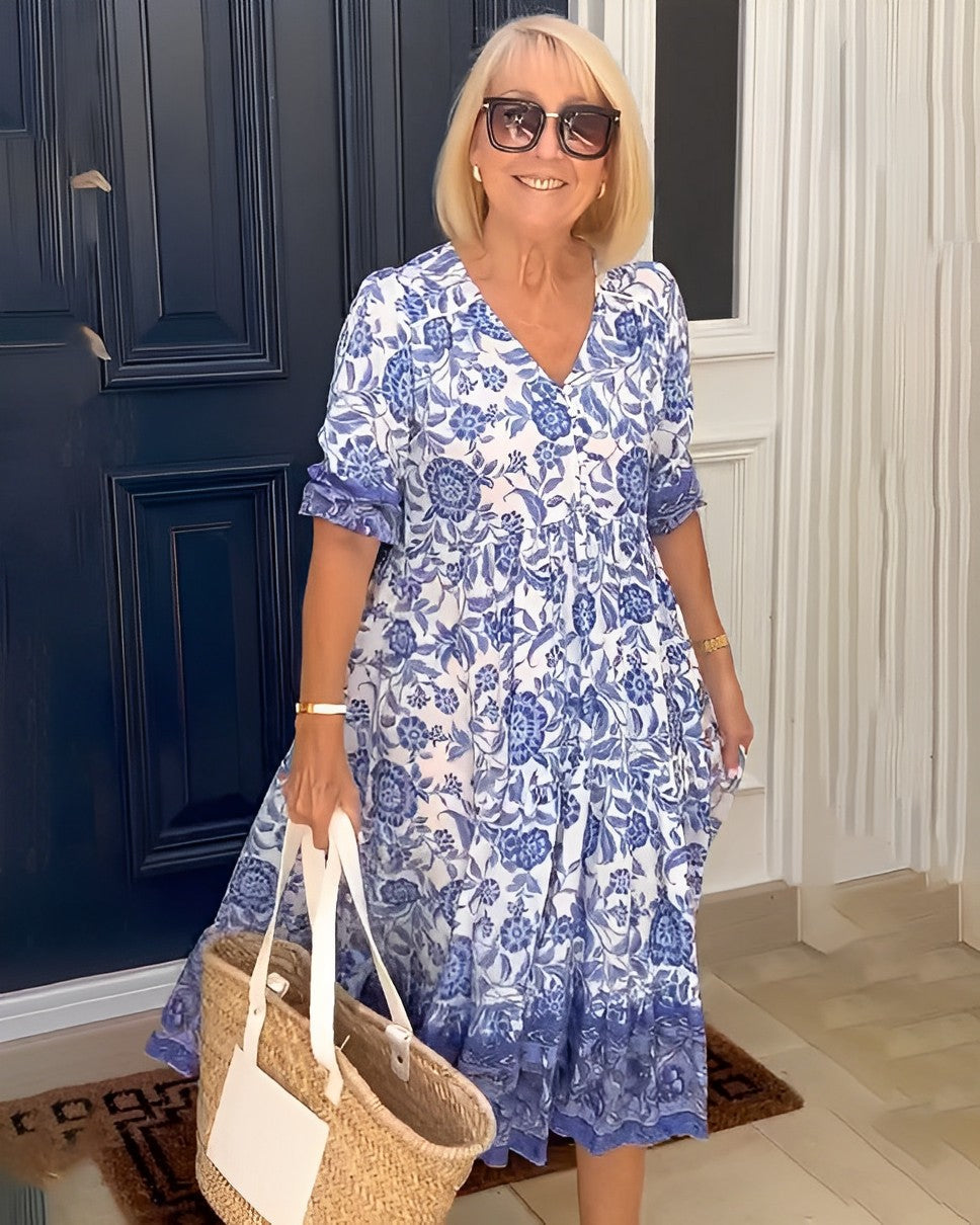 Women's floral V-neck midi dress with three-quarter sleeves and tiered skirt