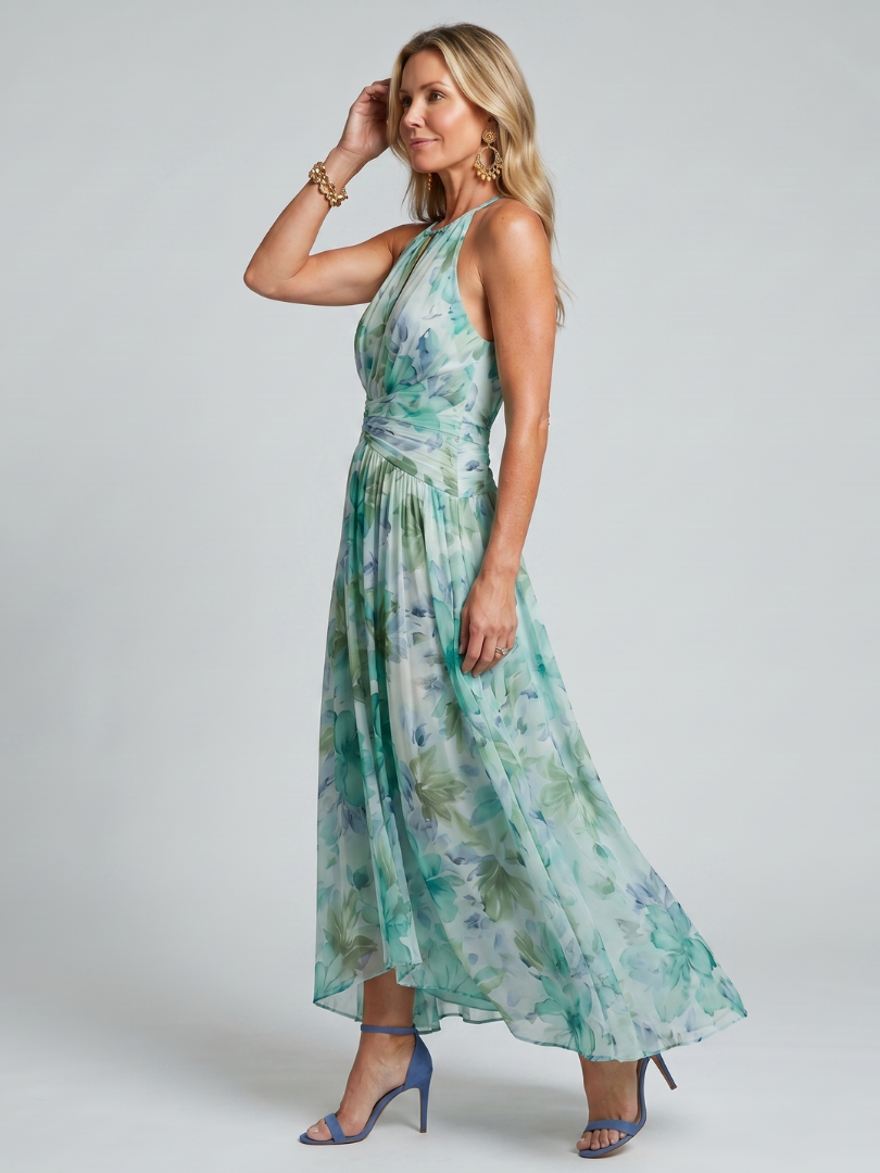 Women's green floral halter maxi dress with pleated waist and flowing skirt