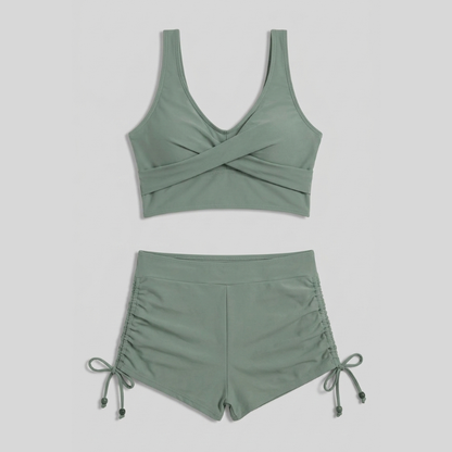 Women's green ruched bikini set with V-neck top and high-waisted shorts
