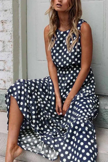 Women's sleeveless polka dot midi dress with a round neckline and flowing skirt