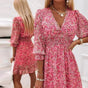Women's floral V-neck mini dress with 3/4 sleeves and smocked waist