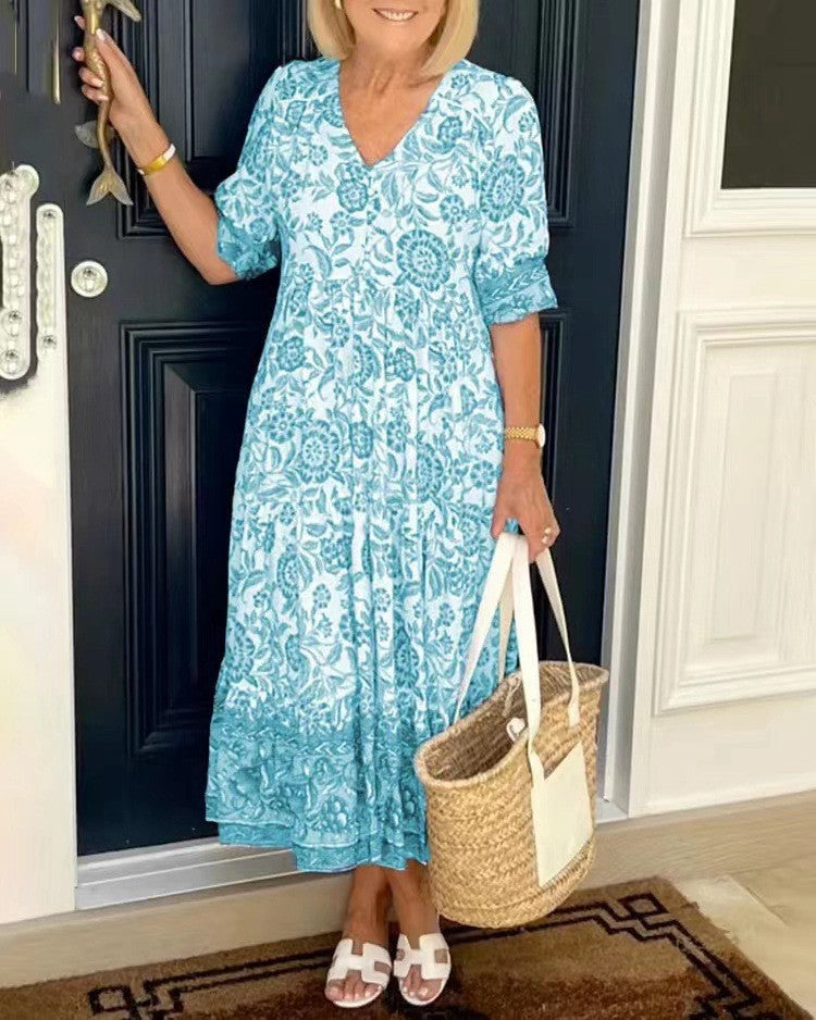 Women's floral V-neck midi dress with three-quarter sleeves and tiered skirt