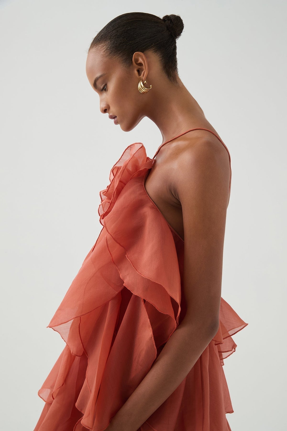 Women's coral sleeveless halter maxi dress with layered ruffles and front flower detail