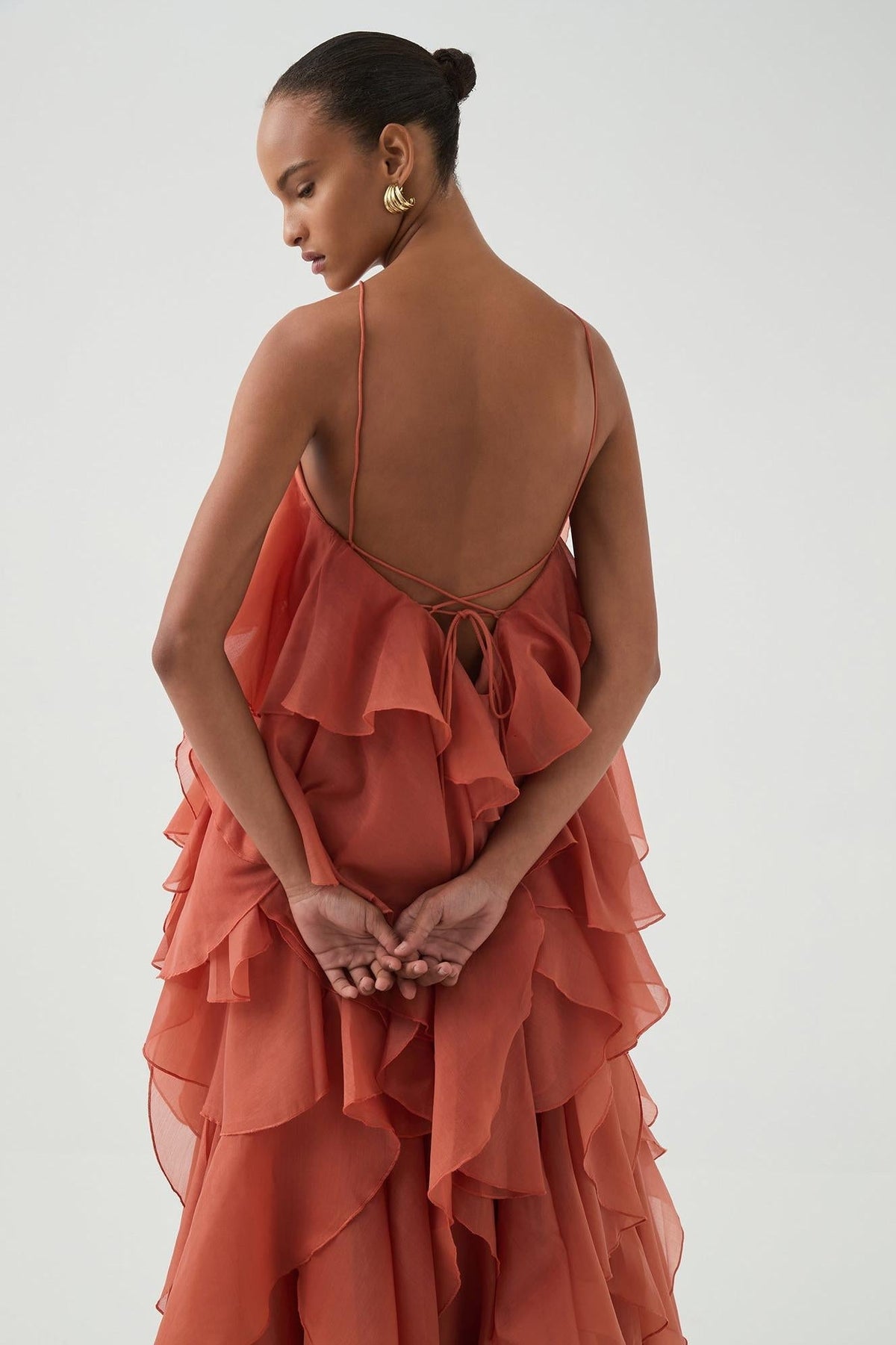 Women's coral sleeveless halter maxi dress with layered ruffles and front flower detail