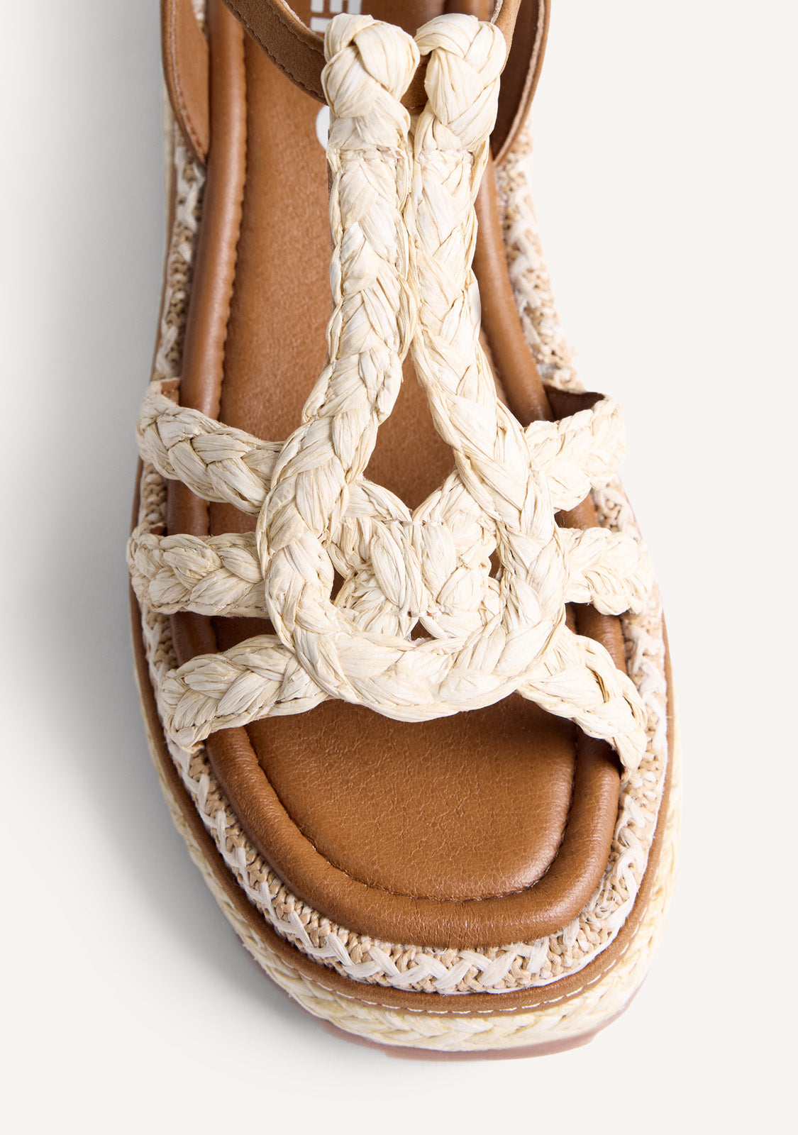 Women's brown wedge sandals with braided straps and ankle buckle