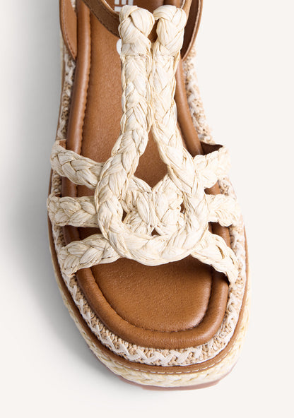 Women's brown wedge sandals with braided straps and ankle buckle