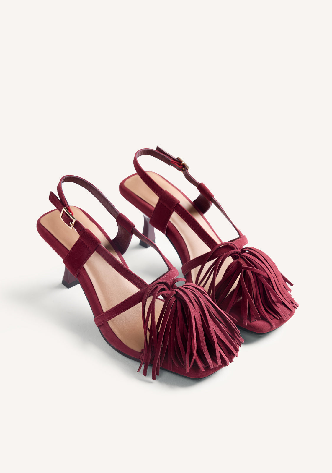 Women's burgundy high-heeled sandals with long fringe front and buckle ankle straps