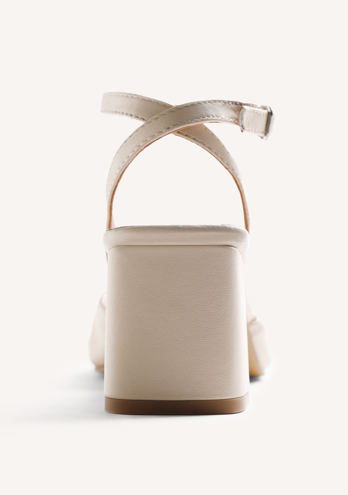 Beige women's heeled sandals with bow detail, silver-tone ornament and ankle buckle strap