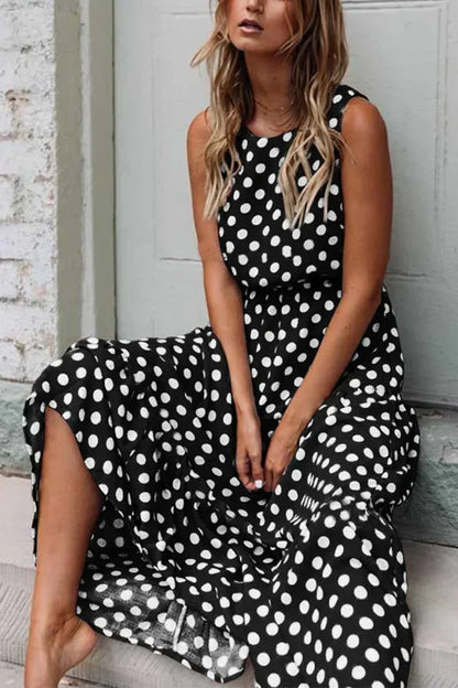 Women's sleeveless polka dot midi dress with a round neckline and flowing skirt