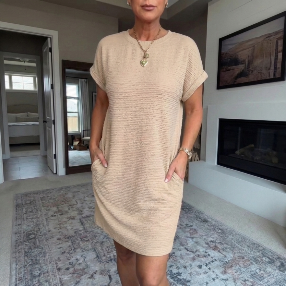 Women's textured short dress with crew neckline, short sleeves and side pockets