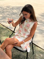 Women's white sleeveless floral A-line mini dress with pink flowers