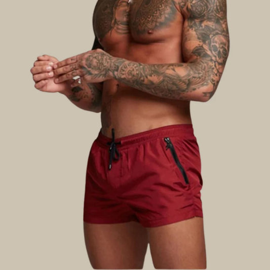 Men's plain swim shorts with elasticated drawstring waist and zipped side pockets