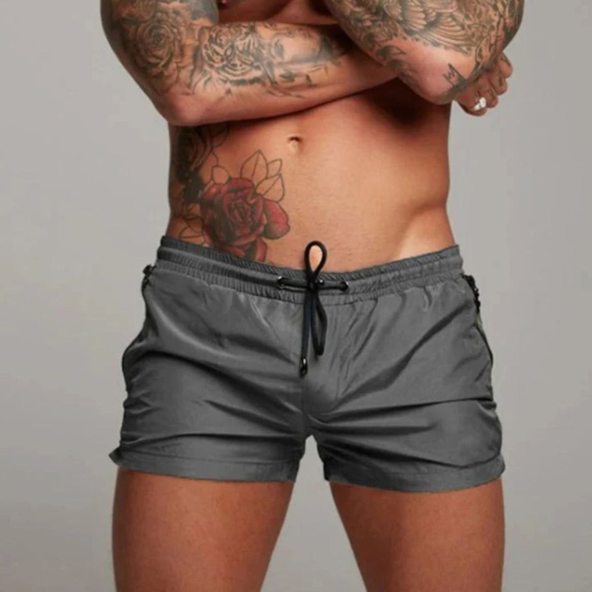Men's plain swim shorts with elasticated drawstring waist and zipped side pockets