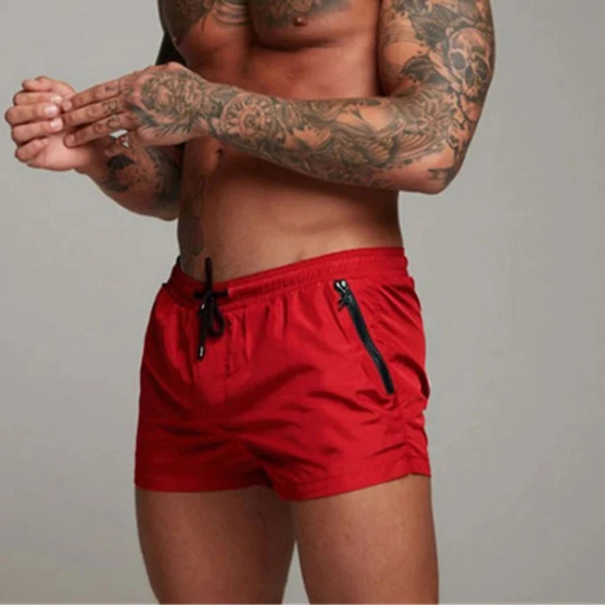 Men's plain swim shorts with elasticated drawstring waist and zipped side pockets