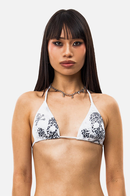 Women's white triangle bikini top with black animal print skull graphics and tie straps
