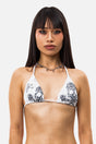 Women's white triangle bikini top with black animal print skull graphics and tie straps
