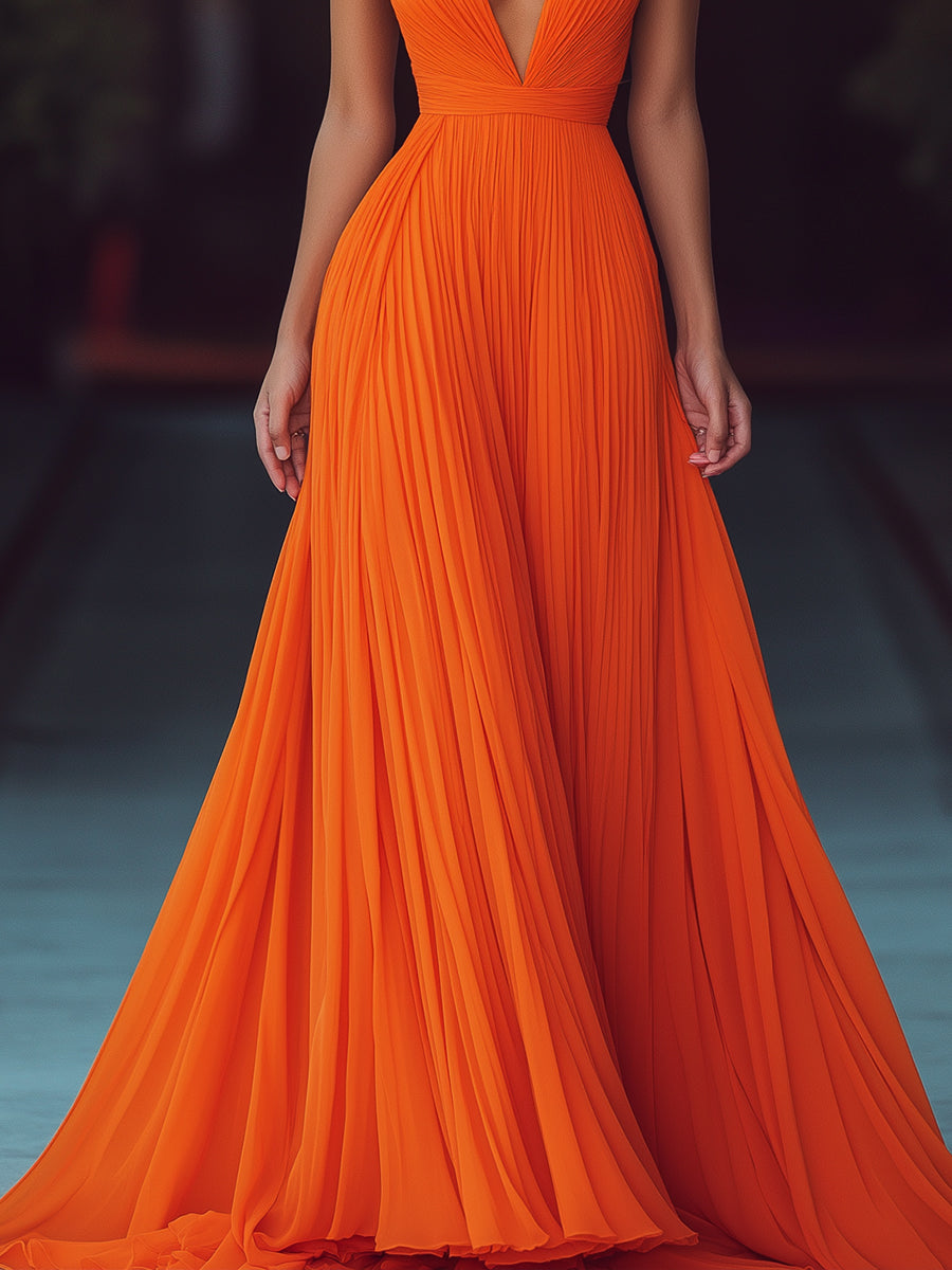 Women's orange pleated halter maxi dress with deep V-neckline and floor-length skirt