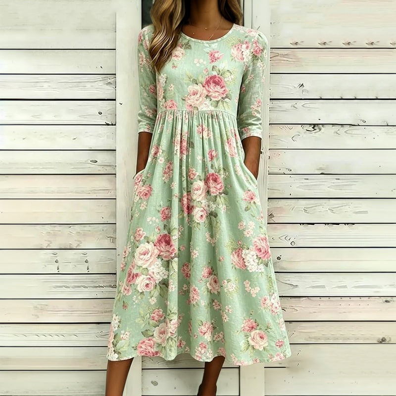 Green floral midi dress with crew neckline, three-quarter sleeves and gathered waist