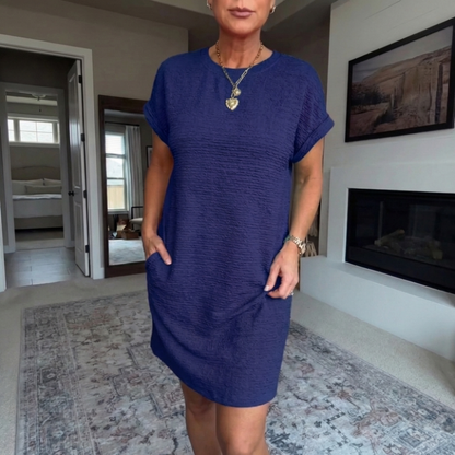 Women's textured short dress with crew neckline, short sleeves and side pockets