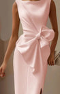 Women's sleeveless knee-length dress with oversized waist bow and draped front
