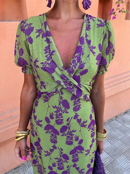 Women's green floral wrap midi dress with purple flowers and short sleeves