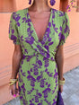 Women's green floral wrap midi dress with purple flowers and short sleeves