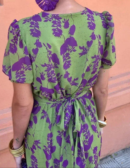 Women's green floral wrap midi dress with purple flowers and short sleeves