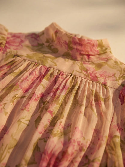 Women's pink floral maxi dress with high neck, puff sleeves and ruffled hem