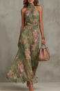 Green floral halter maxi dress with waist sash and flowing skirt